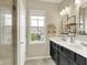 Main bathroom with dual vanity sinks, large mirrors, and a tiled shower at 15116 Fenchurch Dr, Westfield, IN 46074