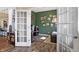Bright office space featuring french doors, hardwood floors, and decorated green walls at 15116 Fenchurch Dr, Westfield, IN 46074
