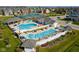 An aerial view showcases a luxurious community pool with ample seating and meticulously manicured landscaping at 15116 Fenchurch Dr, Westfield, IN 46074
