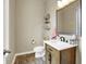 Cozy powder room featuring modern fixtures and wood-look flooring at 15116 Fenchurch Dr, Westfield, IN 46074