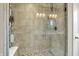 Modern tiled shower with glass door and built-in shelving at 15116 Fenchurch Dr, Westfield, IN 46074