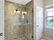 Modern bathroom featuring a large glass shower with stylish tile and pebble flooring at 15116 Fenchurch Dr, Westfield, IN 46074