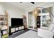 Bright sunroom with entertainment center, bookshelves, and plush chair at 15116 Fenchurch Dr, Westfield, IN 46074