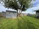 Large backyard with a shed, mature tree, and plenty of green space at 1718 South Dr, Columbus, IN 47203