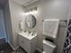Bathroom featuring a white vanity, round mirror and coordinated decorative accents at 1718 South Dr, Columbus, IN 47203