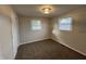 Bedroom featuring two windows, neutral walls, plush carpeting and a closet at 1718 South Dr, Columbus, IN 47203