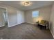 Neutral bedroom with comfortable carpeting, closet, and a cozy seating area at 1718 South Dr, Columbus, IN 47203