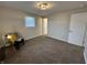 Bright bedroom with neutral walls, plush carpeting, and a comfortable accent chair at 1718 South Dr, Columbus, IN 47203