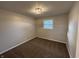 Bedroom featuring a window, neutral walls, plush carpeting and a modern ceiling light at 1718 South Dr, Columbus, IN 47203