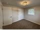 Bright bedroom features a window, neutral walls, plush carpeting and a closet at 1718 South Dr, Columbus, IN 47203