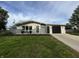 Charming single-story home featuring a well-manicured lawn, attached garage, and modern exterior paint at 1718 South Dr, Columbus, IN 47203
