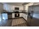 Bright kitchen showcasing white cabinets, stainless steel appliances, and a stylish rug at 1718 South Dr, Columbus, IN 47203