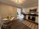 Open kitchen and dining area with stainless steel appliances and clear seating at 1718 South Dr, Columbus, IN 47203