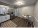 Kitchen and dining area featuring stainless steel refrigerator, white cabinets, and modern decor at 1718 South Dr, Columbus, IN 47203