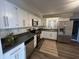 Updated kitchen featuring stainless steel appliances, white cabinetry, and modern countertops at 1718 South Dr, Columbus, IN 47203
