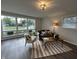 Bright living room featuring large windows, cozy seating, and a stylish striped rug at 1718 South Dr, Columbus, IN 47203