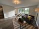 Well-lit living room with a comfortable seating arrangement, large windows, and modern decor at 1718 South Dr, Columbus, IN 47203