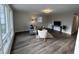 Inviting living room with new gray floors, large windows, and neutral wall paint at 1718 South Dr, Columbus, IN 47203