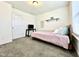 Well-lit bedroom features a comfortable bed, window, and sleek black desk at 1880 Explorer Ct, Franklin, IN 46131