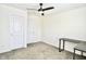 Neutral bedroom with multiple doors, ceiling fan and a desk space at 1880 Explorer Ct, Franklin, IN 46131