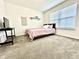 Bright bedroom with a comfy bed, modern decor and a large window at 1880 Explorer Ct, Franklin, IN 46131