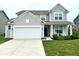 Charming two-story home with a well-manicured lawn, white garage door, and welcoming front porch at 1880 Explorer Ct, Franklin, IN 46131