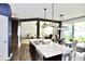Open-concept kitchen with a large island, stainless steel sink, and view into the dining and living spaces at 1880 Explorer Ct, Franklin, IN 46131