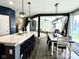 Spacious kitchen with a large island, bar seating, and open views into the dining and living areas at 1880 Explorer Ct, Franklin, IN 46131