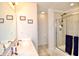 Well-lit main bathroom with double vanity sinks and walk-in glass shower with tile surround at 1880 Explorer Ct, Franklin, IN 46131