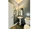 Chic powder room features modern fixtures, stylish vanity, and luxury vinyl flooring at 1880 Explorer Ct, Franklin, IN 46131