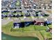 Street view showcasing an area with neatly arranged homes, green lawns and a tranquil pond at 1880 Explorer Ct, Franklin, IN 46131