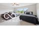 Bright bedroom showcasing two beds with dark headboards, complemented by a matching nightstand and comfortable furnishings at 19175 English Lake Ln, Noblesville, IN 46062