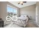 Comfortable bedroom featuring a ceiling fan, neutral walls, and large window offering natural light and outdoor views at 19175 English Lake Ln, Noblesville, IN 46062
