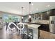 Modern kitchen featuring granite countertops, stainless steel appliances, and a large island at 19175 English Lake Ln, Noblesville, IN 46062