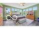 Bright main bedroom with a tufted headboard and nine large windows at 19175 English Lake Ln, Noblesville, IN 46062