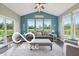 Bright sunroom with comfortable seating, large windows, and view of the backyard at 19175 English Lake Ln, Noblesville, IN 46062