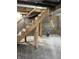 Unfinished basement features include open ceilings and a set of wood stairs at 1931 E 68Th St, Indianapolis, IN 46220