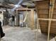 View of the home's unfinished basement with exposed ductwork and the water heater at 1931 E 68Th St, Indianapolis, IN 46220