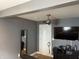Bedroom with a ceiling fan and ample storage, featuring a TV and a full-length mirror for added convenience at 1931 E 68Th St, Indianapolis, IN 46220