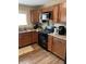 Modern kitchen featuring wooden cabinets, granite countertops, and stainless steel appliances for a sleek and efficient cooking space at 1931 E 68Th St, Indianapolis, IN 46220