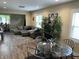 Inviting living room featuring hardwood floors, a large sectional couch, and ample natural light from the surrounding windows at 1931 E 68Th St, Indianapolis, IN 46220
