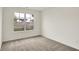 Vacant bedroom with neutral walls and carpet plus a neighborhood view from the window at 19584 Atwater Ave, Sheridan, IN 46069
