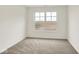 Empty bedroom with neutral walls and carpet plus view to the vacant lot at 19584 Atwater Ave, Sheridan, IN 46069