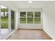 Bright dining area with wood floors, large windows overlooking the backyard, and sliding glass door at 19584 Atwater Ave, Sheridan, IN 46069