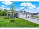 Charming home with a blue-grey exterior, stone accents, and a well-manicured front lawn and landscaping at 19584 Atwater Ave, Sheridan, IN 46069