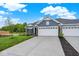 Attractive home with a blue-grey exterior, stone accents, and a wide driveway leading to the garage at 19584 Atwater Ave, Sheridan, IN 46069