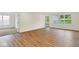 Bright living room with wood floors, many windows, and an open doorway at 19584 Atwater Ave, Sheridan, IN 46069
