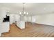 Open-concept living room with wood floors, kitchen island, and plenty of natural light at 19584 Atwater Ave, Sheridan, IN 46069