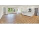 Open-concept living room with wood floors and an adjacent kitchen and dining area at 19584 Atwater Ave, Sheridan, IN 46069