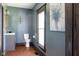 Charming bathroom featuring penny tile floor, elegant fixtures, and blue painted walls at 2215 S Delaware St, Indianapolis, IN 46225